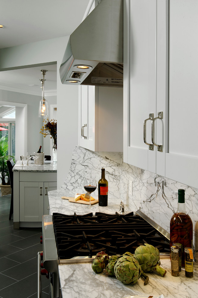 Design ideas for a mid-sized traditional l-shaped eat-in kitchen in DC Metro with an undermount sink, shaker cabinets, white cabinets, granite benchtops, multi-coloured splashback, ceramic splashback, stainless steel appliances, with island and porcelain floors.