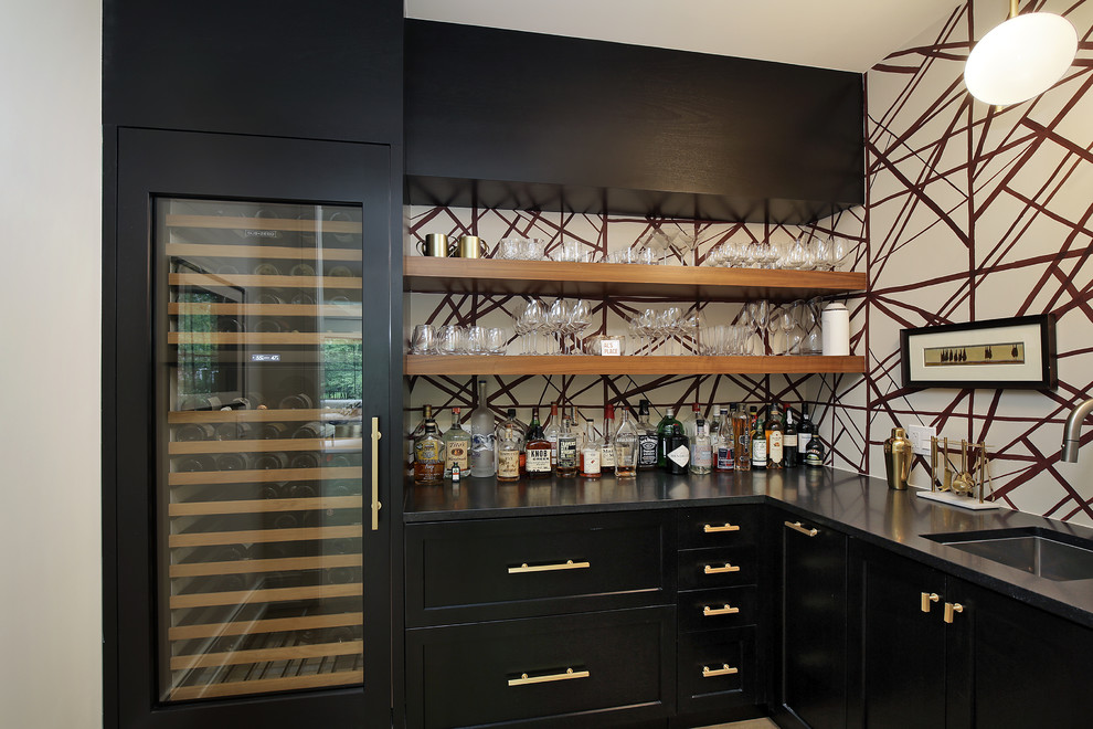 Inspiration for a large transitional l-shaped wet bar in Chicago with an undermount sink, black cabinets, quartzite benchtops, multi-coloured splashback, black benchtop and shaker cabinets.