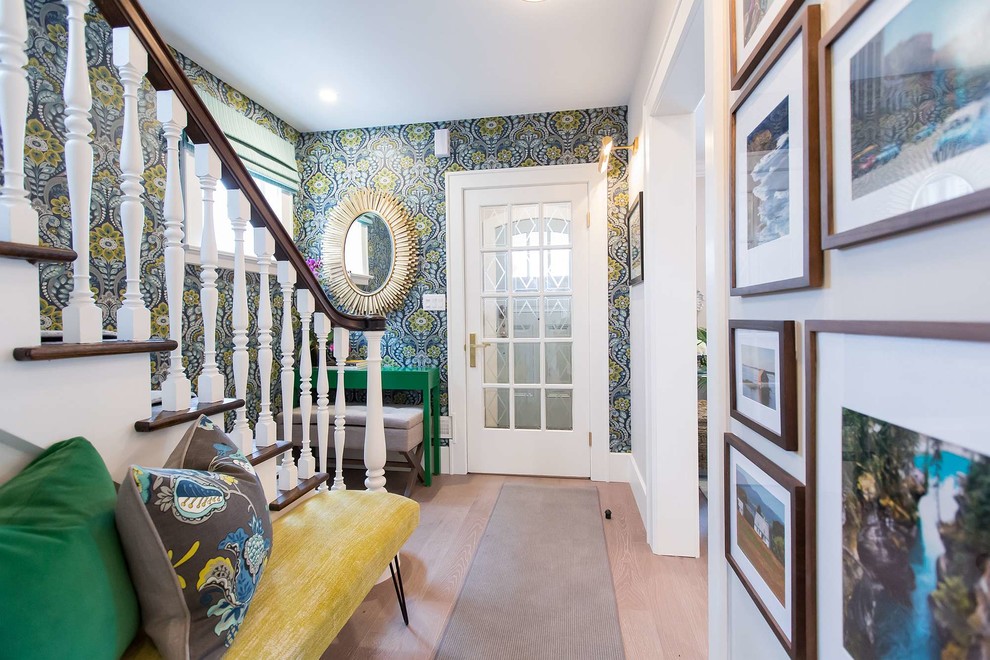 Entryway - transitional medium tone wood floor and brown floor entryway idea in Toronto with white walls and a gray front door