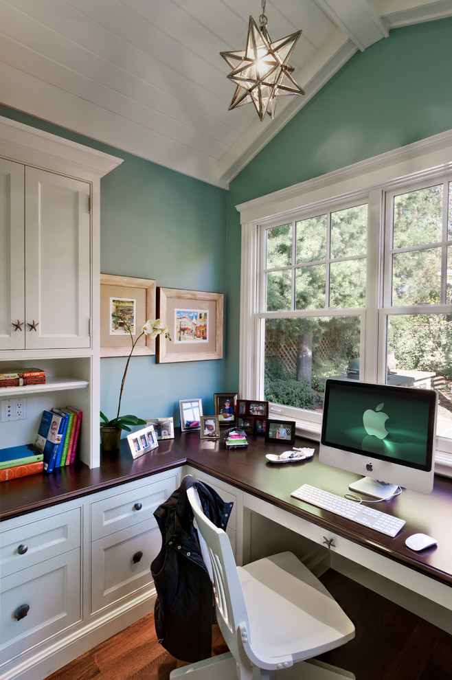 Photo of a traditional home office in San Francisco with blue walls, dark hardwood floors and a built-in desk.
