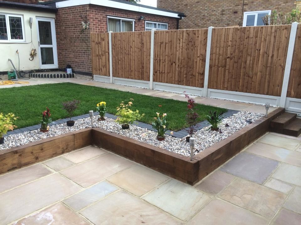 Inspiration for a large contemporary backyard partial sun formal garden for summer in Essex with decking.