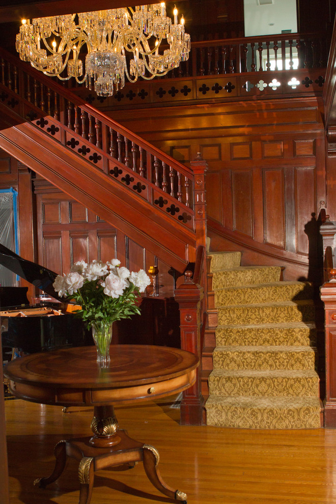 Large traditional carpeted l-shaped staircase in Boston with wood risers.