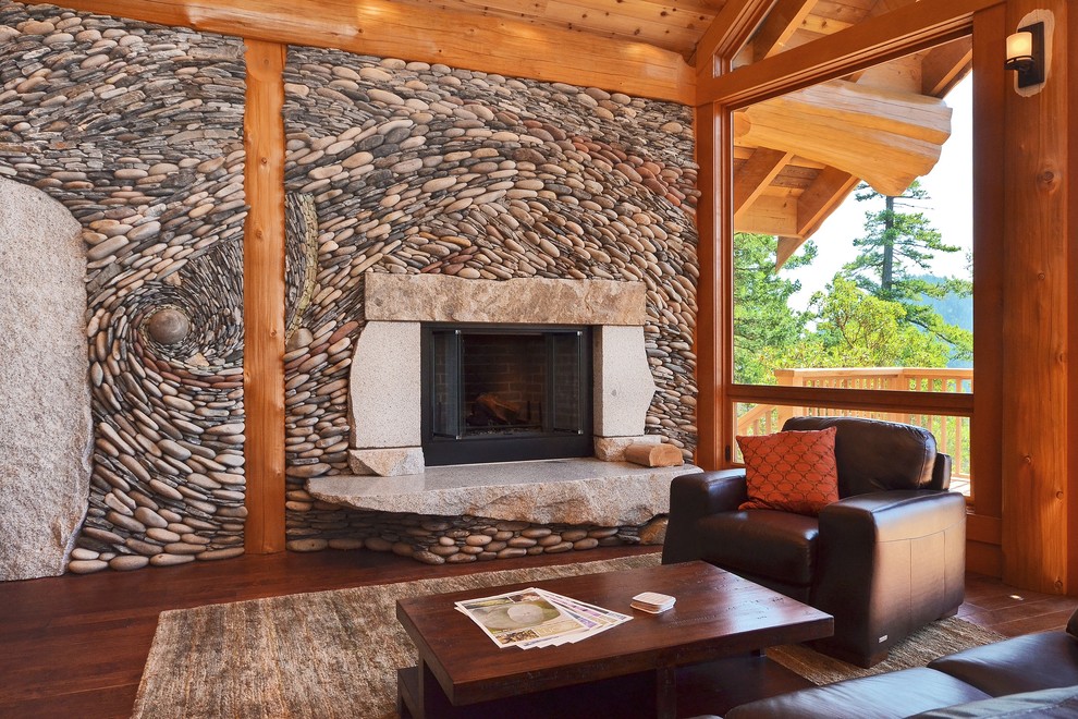 This is an example of a country living room in Vancouver with a corner fireplace and a stone fireplace surround.