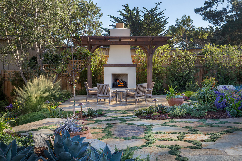 Inspiration for a mediterranean backyard stone and wood fence landscaping with a pergola.