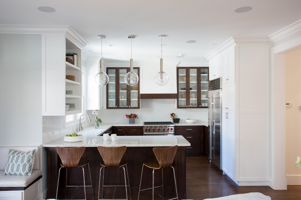 Inspiration for a contemporary u-shaped open plan kitchen in San Francisco with an undermount sink, shaker cabinets, medium wood cabinets, white splashback, stainless steel appliances, medium hardwood floors and a peninsula.