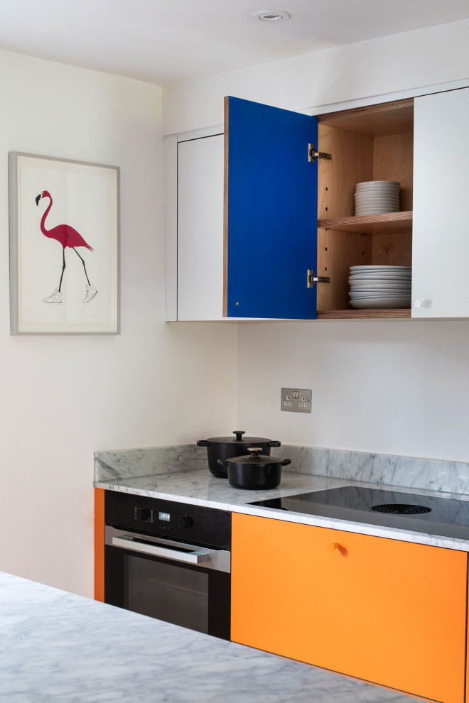 Inspiration for a large contemporary u-shaped separate kitchen in London with an integrated sink, flat-panel cabinets, orange cabinets, stainless steel appliances and with island.