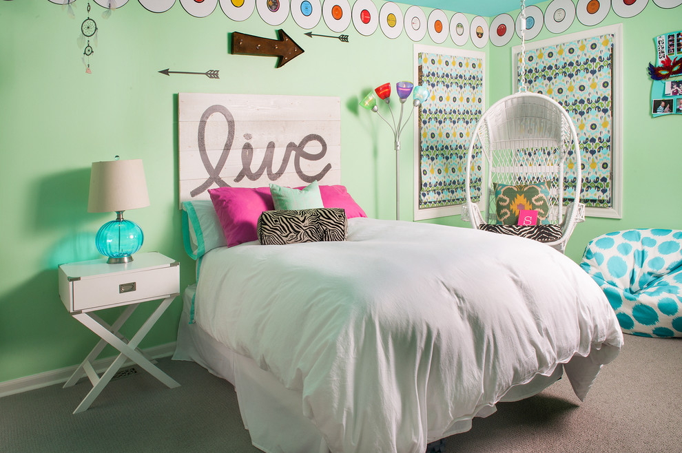 This is an example of a contemporary kids' room for girls in Chicago with green walls and carpet.