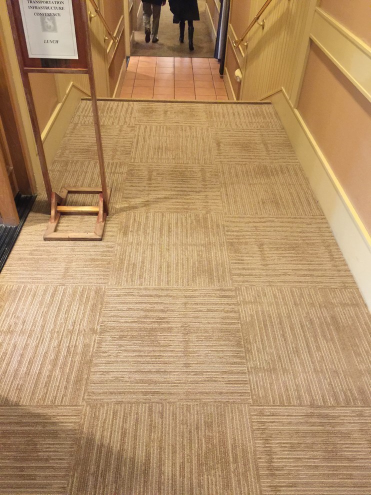 Photo of a mid-sized transitional hallway in San Francisco with beige walls, carpet and beige floor.