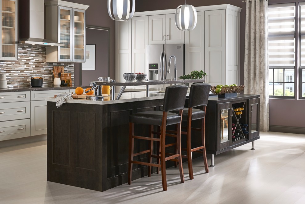Example of a large transitional l-shaped eat-in kitchen design with shaker cabinets, white cabinets and an island