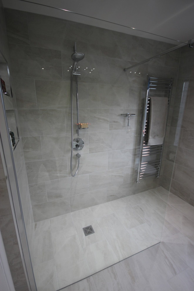 This is an example of a mid-sized contemporary 3/4 bathroom in Surrey with white cabinets, an open shower, gray tile, porcelain tile, yellow walls, porcelain floors and a wall-mount sink.