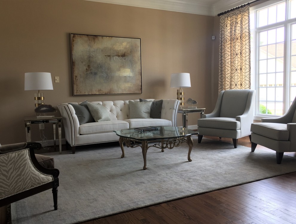 This is an example of a mid-sized traditional open concept living room in DC Metro with beige walls, medium hardwood floors, no fireplace and brown floor.