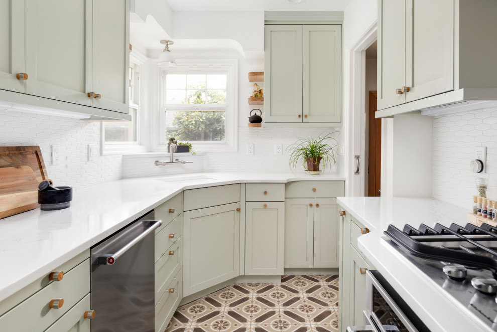 Small transitional separate kitchen in Portland with white splashback, white benchtop, an undermount sink, shaker cabinets, green cabinets, stainless steel appliances, quartz benchtops, ceramic splashback, cement tiles and brown floor.