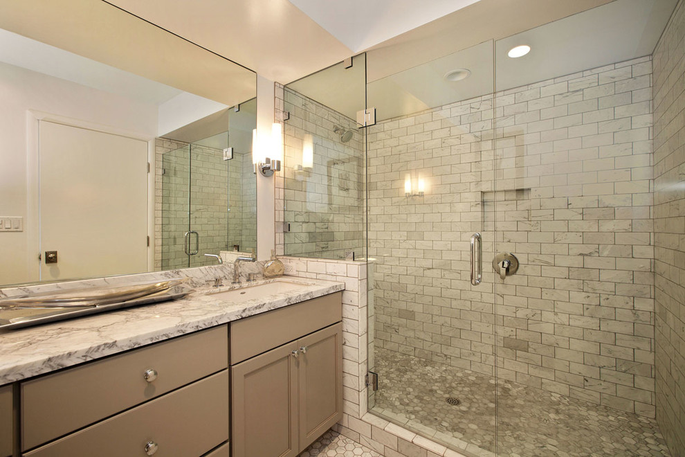 This is an example of a large contemporary master bathroom in San Francisco with recessed-panel cabinets, beige cabinets, marble benchtops, an alcove shower, gray tile, mosaic tile, beige walls and pebble tile floors.