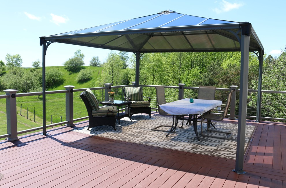 This is an example of an expansive country rooftop deck in Minneapolis with a pergola.