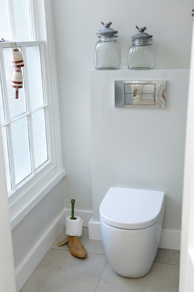 Small traditional powder room in Cambridgeshire with a wall-mount toilet and grey walls.