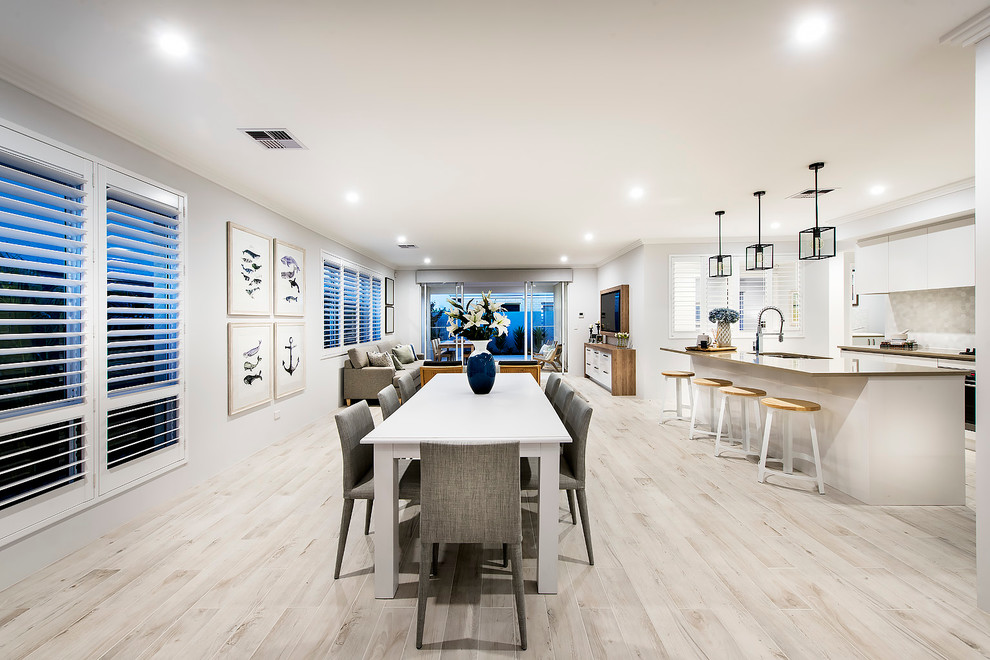 Design ideas for a beach style kitchen/dining combo in Perth with white walls and limestone floors.