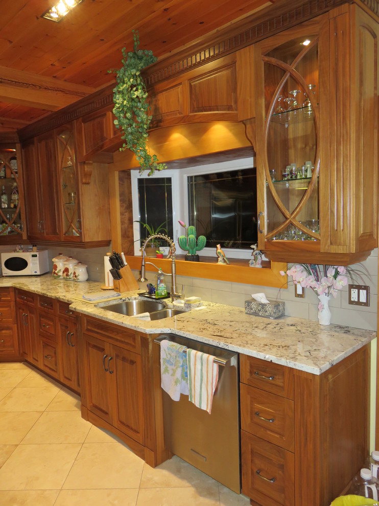 Large transitional l-shaped ceramic tile open concept kitchen photo with raised-panel cabinets, medium tone wood cabinets, granite countertops, stainless steel appliances, an island, a double-bowl sink, white backsplash and subway tile backsplash