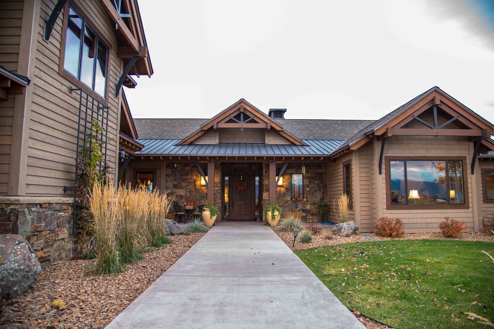 Example of a mid-sized mountain style front door design with a dark wood front door