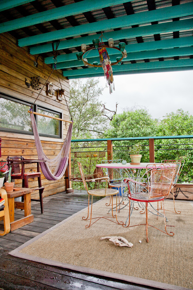 Design ideas for an eclectic deck in Austin with a roof extension.