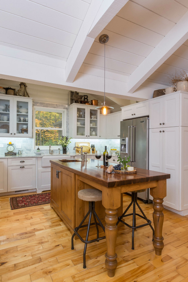 Design ideas for a traditional kitchen in Columbus with shaker cabinets, a farmhouse sink, white cabinets and blue splashback.