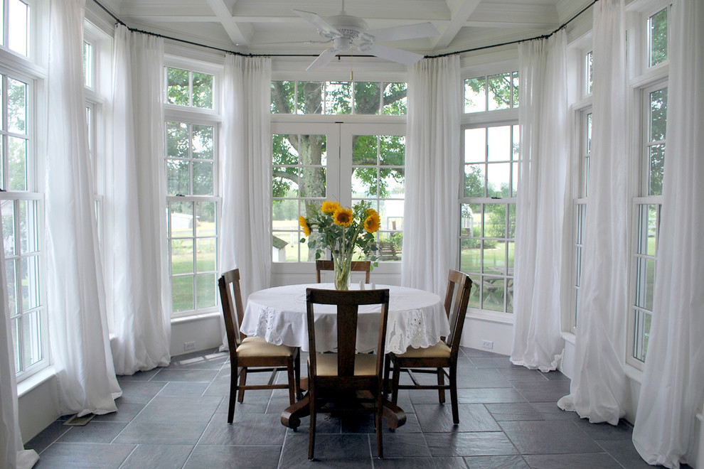 Photo of a traditional dining room in Other with white walls.