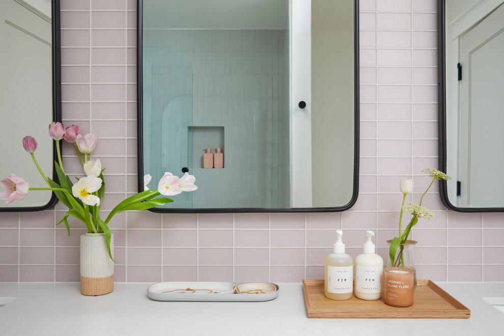 Mid-sized scandinavian kids bathroom in San Francisco with shaker cabinets, light wood cabinets, an alcove tub, a shower/bathtub combo, pink tile, glass tile, white walls, terrazzo floors, an undermount sink, engineered quartz benchtops, white floor, a hinged shower door, white benchtops, a niche, a double vanity and a built-in vanity.