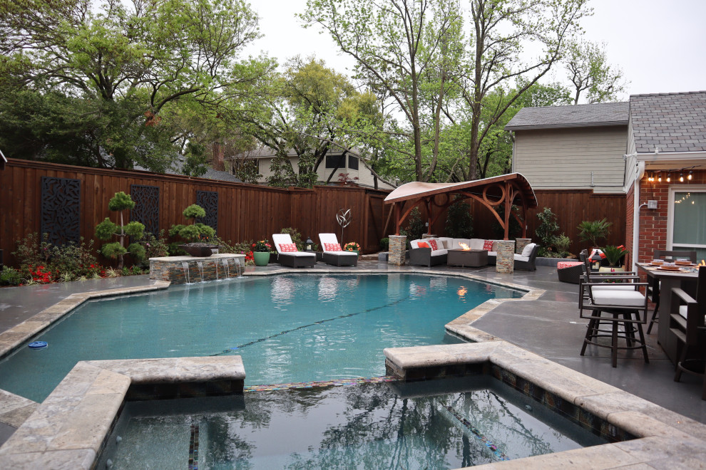 Inspiration for an expansive contemporary backyard custom-shaped lap pool in Dallas with a hot tub and concrete slab.