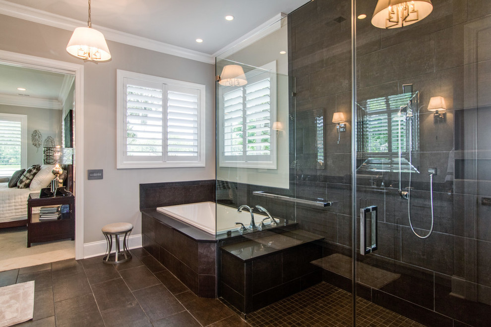 Photo of a large contemporary master bathroom in Charleston with shaker cabinets, grey cabinets, a drop-in tub, brown tile, porcelain tile, engineered quartz benchtops, a curbless shower, a one-piece toilet, grey walls, porcelain floors, an undermount sink, brown floor and a hinged shower door.