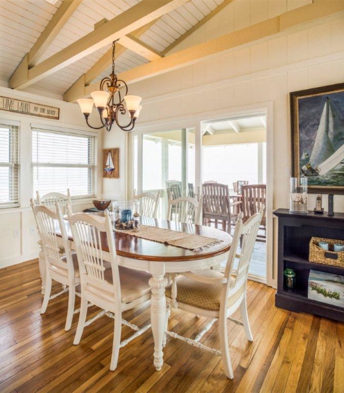 Inspiration for a beach style open plan dining in Atlanta with white walls and medium hardwood floors.