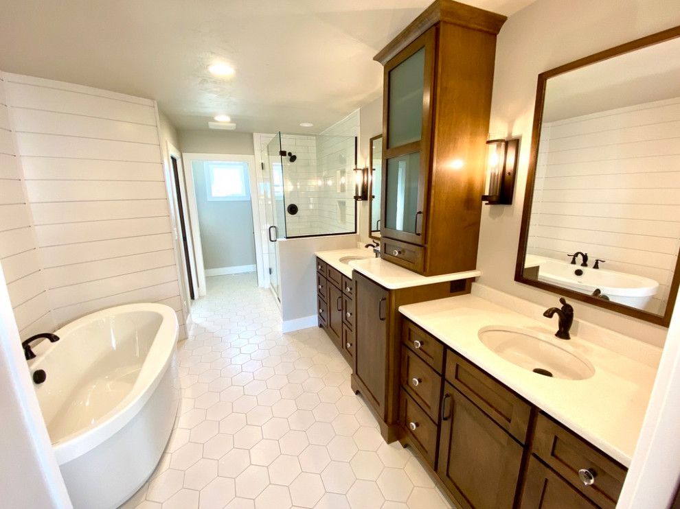 Photo of a large country master bathroom in Other with white cabinets, a freestanding tub, a corner shower, a two-piece toilet, grey walls, cement tiles, an integrated sink, engineered quartz benchtops, white floor, a hinged shower door, white benchtops, a double vanity, a built-in vanity and planked wall panelling.