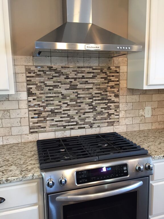 Example of a mid-sized transitional kitchen design with granite countertops, beige backsplash, stone tile backsplash and stainless steel appliances