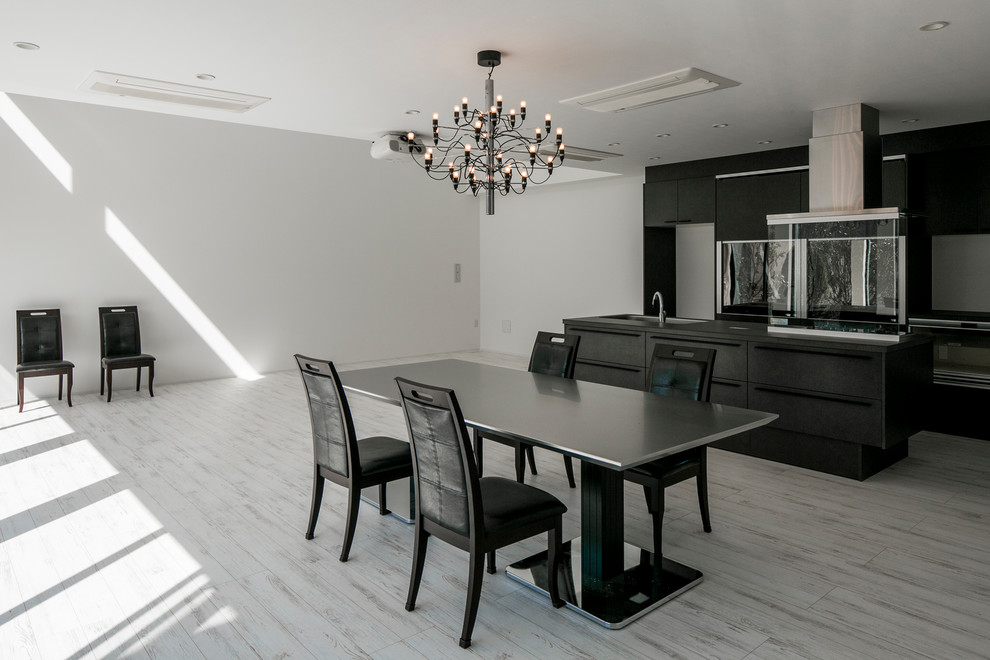 Inspiration for a contemporary dining room in Tokyo with white walls and grey floor.