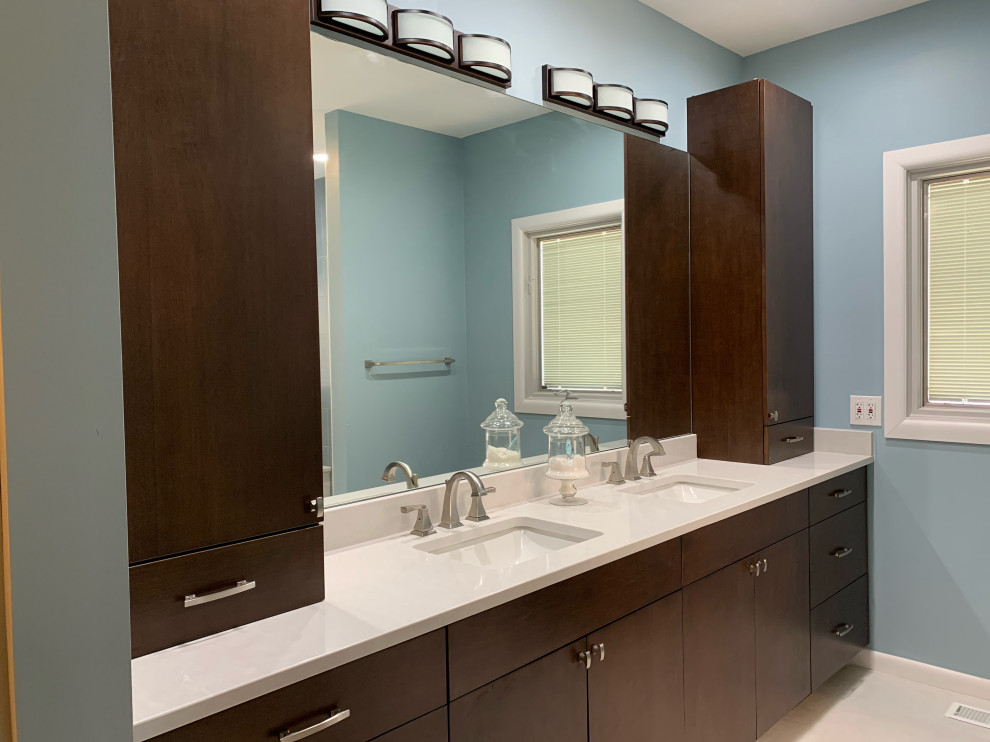 Photo of a medium sized modern ensuite bathroom in Cincinnati with flat-panel cabinets, dark wood cabinets, a built-in bath, a double shower, a two-piece toilet, porcelain tiles, blue walls, porcelain flooring, a submerged sink, engineered stone worktops, white floors, a hinged door, white worktops, a shower bench, double sinks, a built in vanity unit and white tiles.