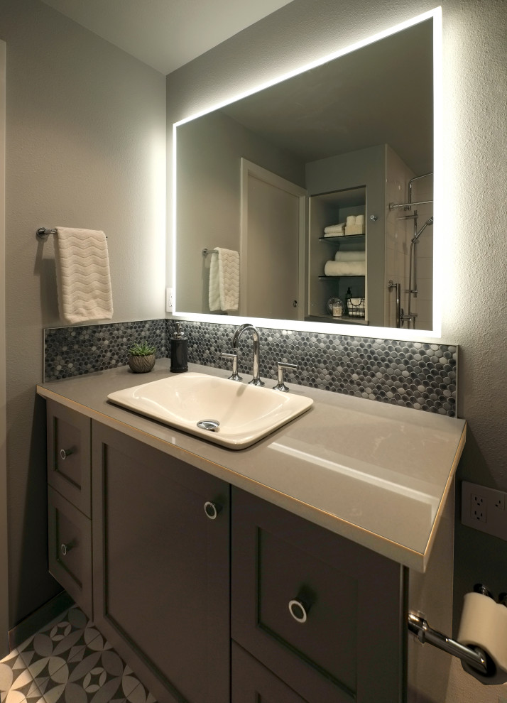 Design ideas for a small contemporary master bathroom in Seattle with grey cabinets, an alcove tub, a shower/bathtub combo, a one-piece toilet, multi-coloured tile, porcelain tile, grey walls, mosaic tile floors, a vessel sink, engineered quartz benchtops, multi-coloured floor, a shower curtain and white benchtops.