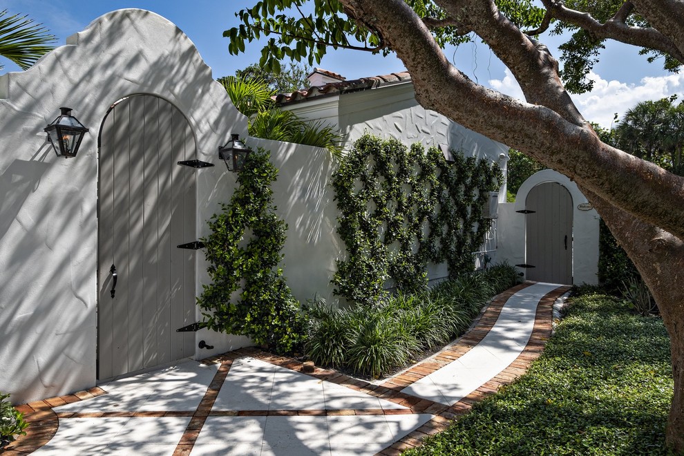 Design ideas for a mediterranean front yard garden in Miami with a garden path and concrete pavers.