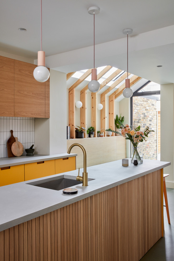 Design ideas for a contemporary kitchen in London with an undermount sink, flat-panel cabinets, pink cabinets, concrete benchtops, white splashback, ceramic splashback, linoleum floors, with island, green floor, grey benchtop and timber.