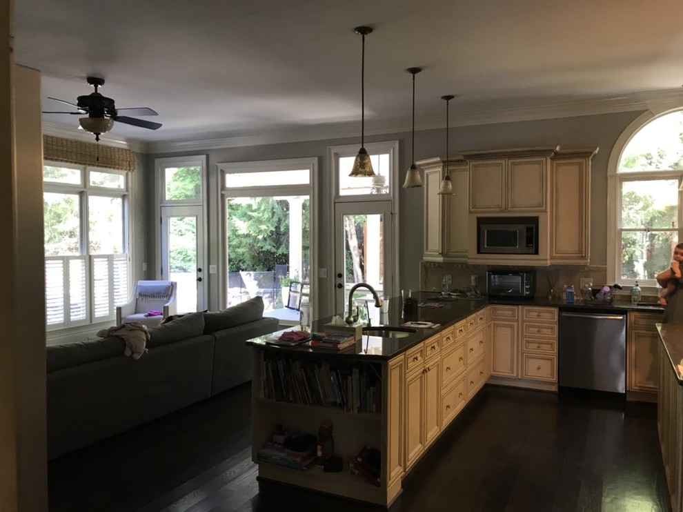 Photo of a large arts and crafts u-shaped eat-in kitchen in Atlanta with an undermount sink, recessed-panel cabinets, white cabinets, quartz benchtops, white splashback, stone slab splashback, stainless steel appliances, dark hardwood floors, a peninsula, brown floor and white benchtop.