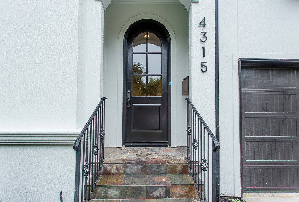 Inspiration for a mid-sized transitional front door remodel in Houston with white walls and a black front door