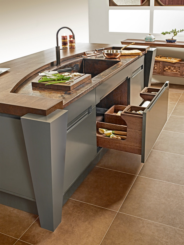 Small asian u-shaped eat-in kitchen in Other with recessed-panel cabinets, light wood cabinets, copper benchtops, stone slab splashback, with island and an integrated sink.