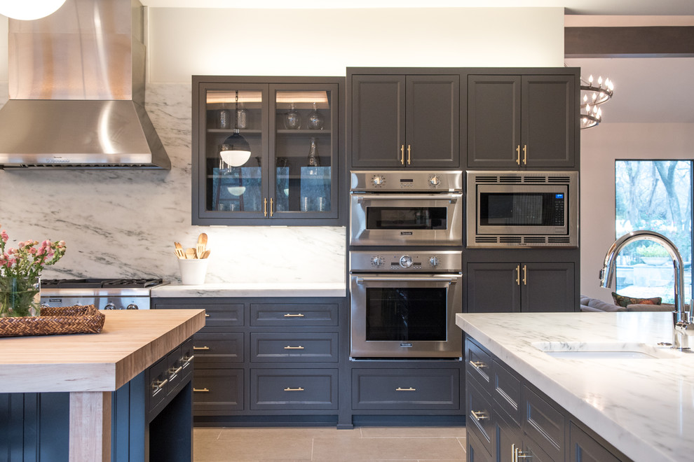 Design ideas for a large transitional l-shaped eat-in kitchen in Dallas with a drop-in sink, beaded inset cabinets, grey cabinets, marble benchtops, white splashback, limestone floors, with island, beige floor, stone slab splashback and stainless steel appliances.