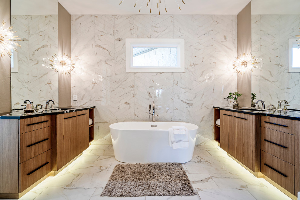 Inspiration for a contemporary master bathroom in San Francisco with flat-panel cabinets, medium wood cabinets, a freestanding tub, white tile, an undermount sink, white floor and black benchtops.