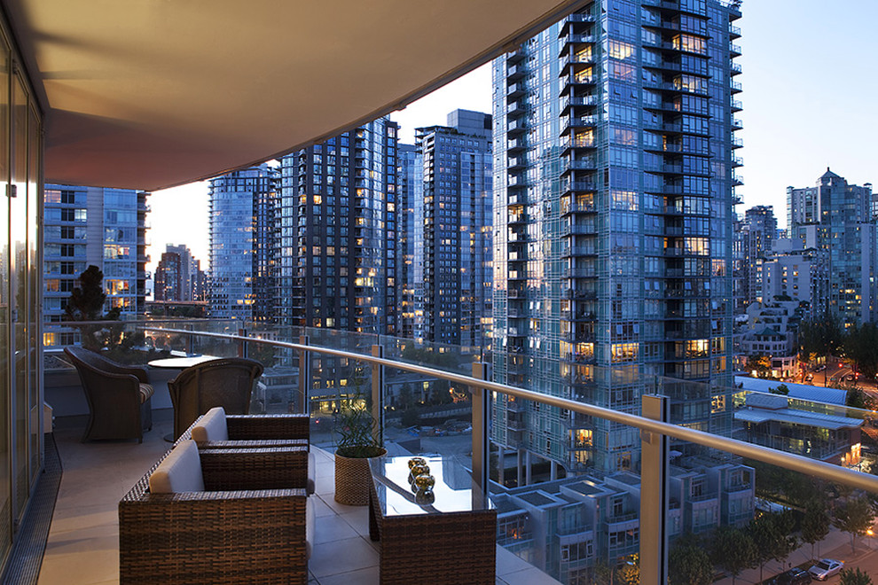 Design ideas for a contemporary balcony in Vancouver with a roof extension.