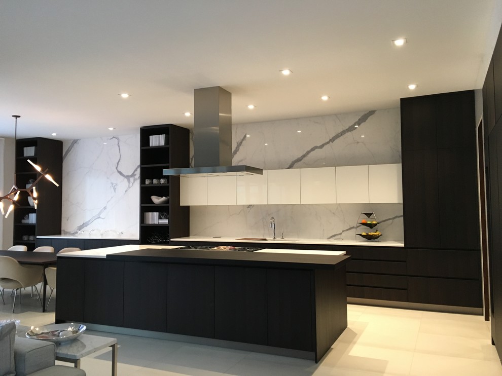 Photo of a large contemporary single-wall open plan kitchen in Other with flat-panel cabinets, white cabinets, grey splashback, stone slab splashback, panelled appliances, ceramic floors and with island.
