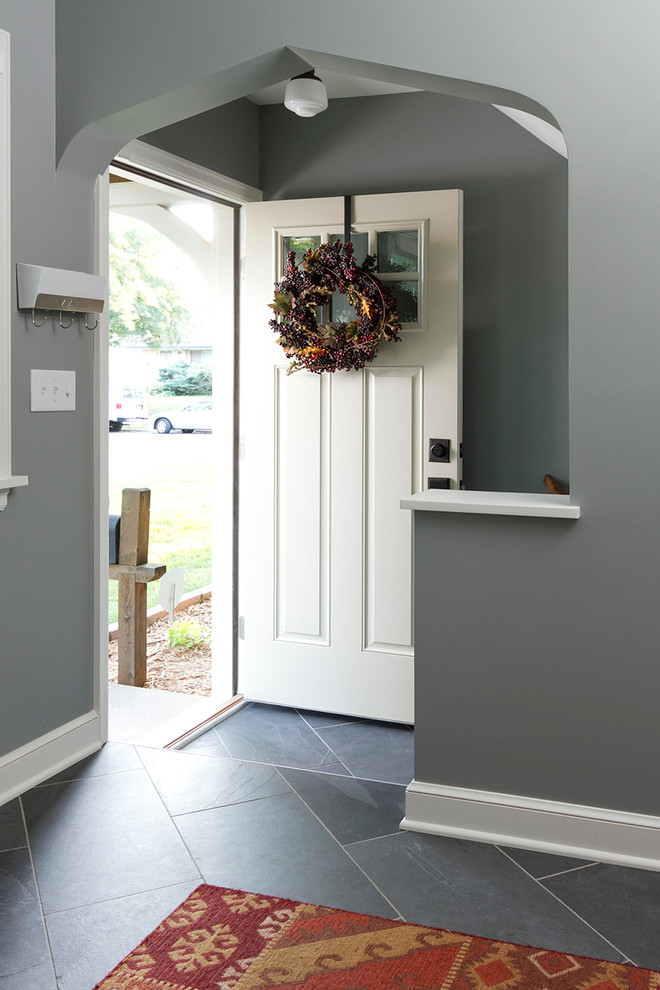 Design ideas for a traditional mudroom in Minneapolis with grey floor.