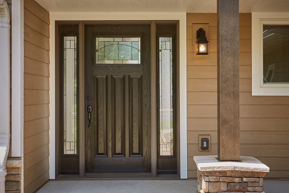This is an example of a traditional front door in Other with a single front door and a dark wood front door.