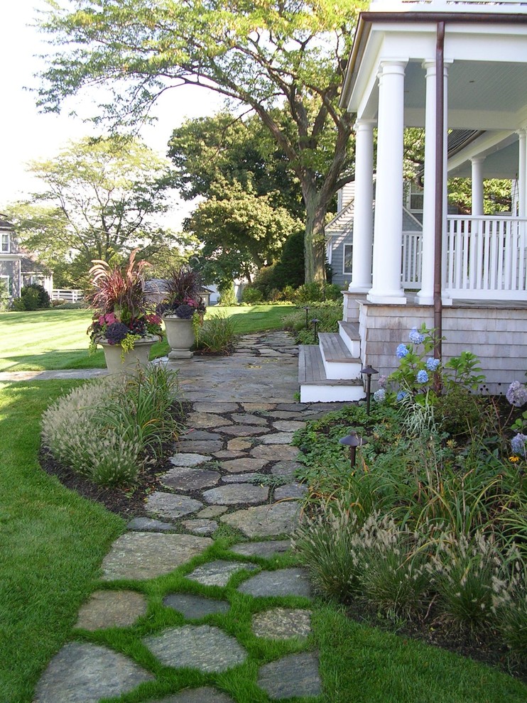 Photo of a large beach style front yard garden in Boston with a container garden and natural stone pavers.