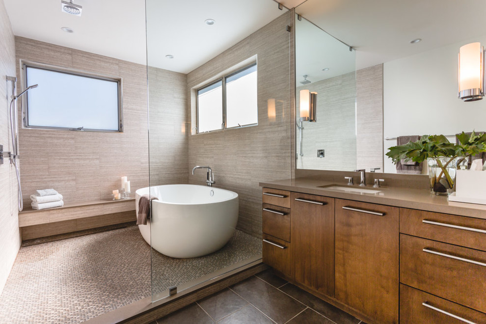 This is an example of a contemporary master wet room bathroom in Los Angeles with flat-panel cabinets, medium wood cabinets, a freestanding tub, gray tile, ceramic floors, an undermount sink, engineered quartz benchtops and an open shower.