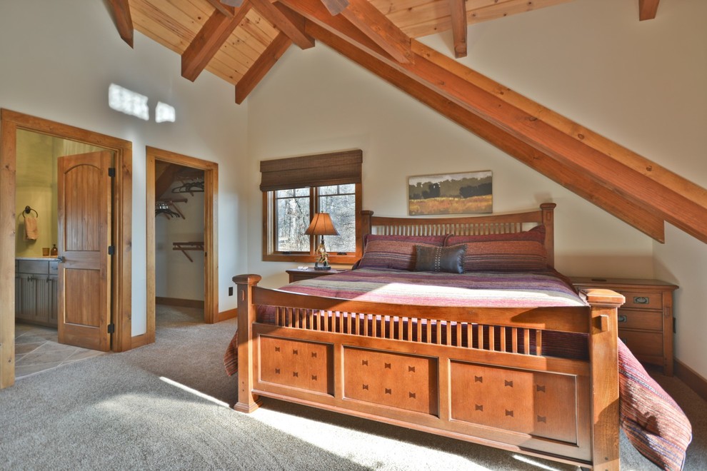 Mid-sized country master bedroom in Other with beige walls, no fireplace, carpet and beige floor.
