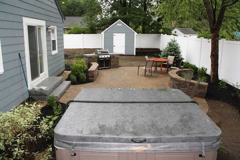 Design ideas for a small modern backyard patio in Boston with concrete pavers.