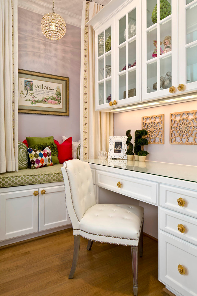 Design ideas for a traditional home office in Dallas with purple walls, medium hardwood floors and a built-in desk.
